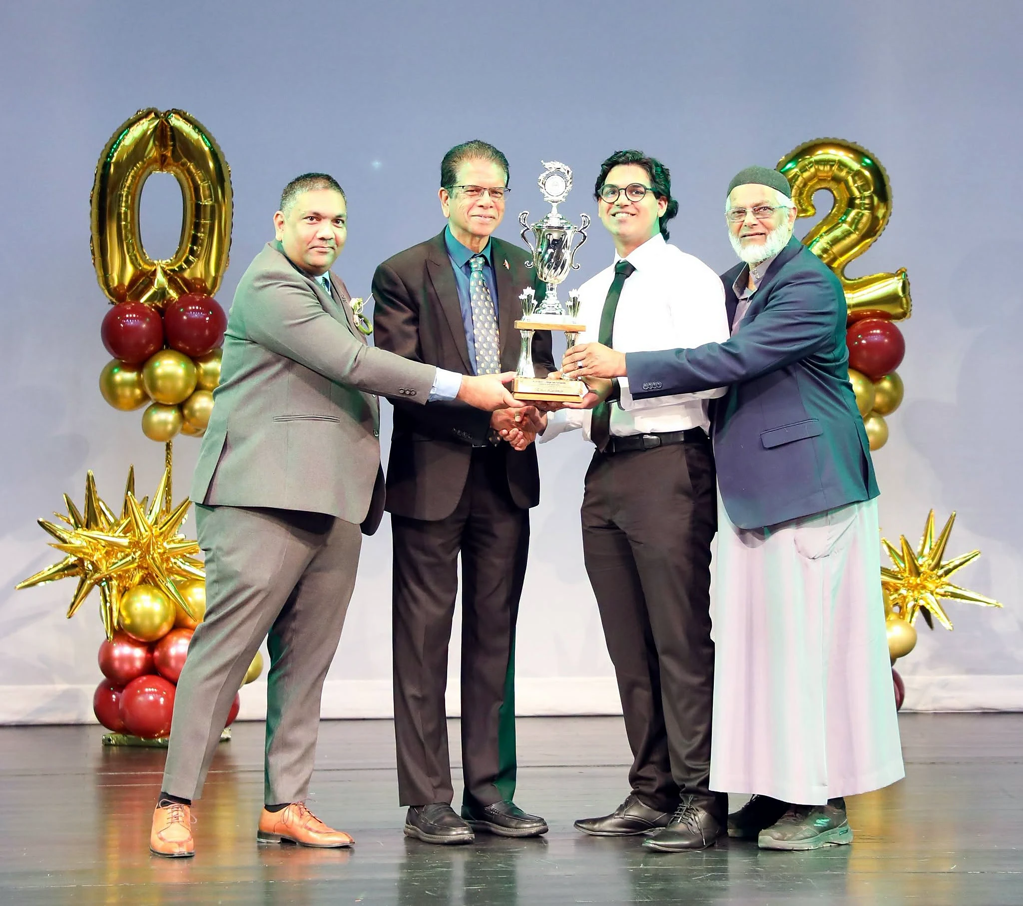 A trophy being presented to a student awardee